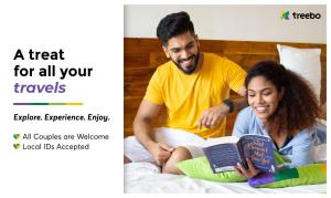 Un uomo e una donna seduti su un letto a leggere libri di Treebo The Utsav, Nashik a Nashik