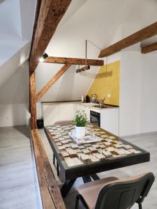 a dining room with a table and a kitchen at Apartmán č2 - 450 m od centra Bojníc in Bojnice