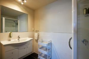 a bathroom with a sink and a mirror at Waves on the Esplanade in Kaikoura