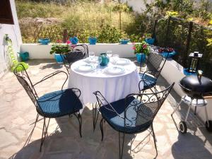 a white table and chairs on a patio at Agrampeli in Limenaria