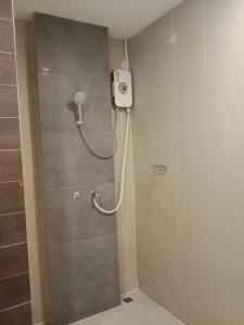 a shower with a shower head in a bathroom at Baan Ampai Beach Hotel in Hua Thanon Beach