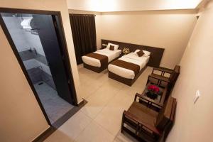 Postel nebo postele na pokoji v ubytování HOTEL PANKAJ RESIDENCY