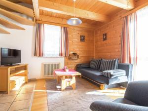 a living room with a couch and a tv at Beautiful Holiday Home in Weinebene with Sauna in Posch Alpe