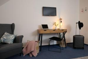 a room with a desk with a laptop computer on it at Hotel Baroko in Prague