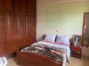 a small bedroom with a bed with at MANOIR DES PRINCESSES BAFOUSSAM in Bafoussam