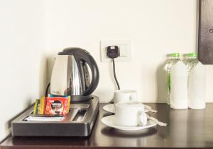 a coffee maker and a cup on a table at Lagoon Paradise Beach Resort in Tangalle