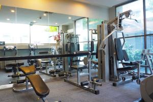 a gym with a lot of treadmills and machines at FuramaXclusive Sukhumvit in Bangkok