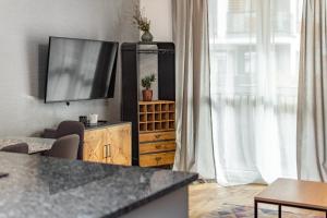 a living room with a flat screen tv on a wooden cabinet at Jurajska 4 by Homeprime in Warsaw