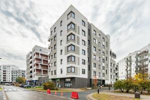 a white building on the side of a street at Jurajska 4 by Homeprime in Warsaw