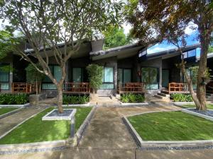 a building with trees in front of it at Family House Zen Boutique Resort in Pai