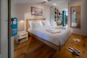 a bedroom with a bed with white sheets and a mirror at Centro Storico in Neviglie