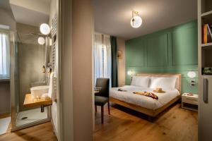 a bedroom with a bed and a desk and a chair at Centro Storico in Neviglie +5 photos