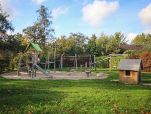 a park with a playground with a slide and a swing at Huisje 11 Wemeldinge in Wemeldinge