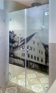a glass door with a view of a building at Rose Bistro & Gästezimmer in Altensteig