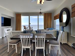 a dining room and living room with a table and chairs at Indigo West #2004 in Perdido Key