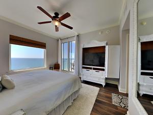 a bedroom with a large bed and a television at Indigo West #2004 in Perdido Key +28 photos