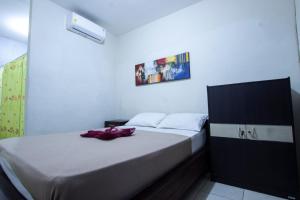 Postel nebo postele na pokoji v ubytování Putra Dadi Guest House