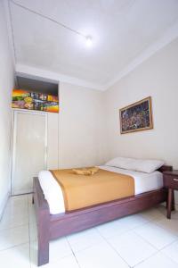 Postel nebo postele na pokoji v ubytování Putra Dadi Guest House