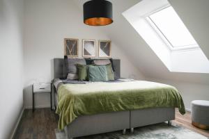 a bedroom with a bed and a skylight at Modernes Loft in Ramstein - mit Sauna & TLA in Ramstein-Miesenbach