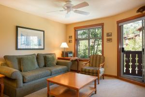 a living room with a couch and a table at 2211 - Two Bedroom Standard Eagle Springs East condo in Solitude