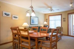 a dining room and living room with a table and chairs at 2211 - Two Bedroom Standard Eagle Springs East condo in Solitude +5 photos