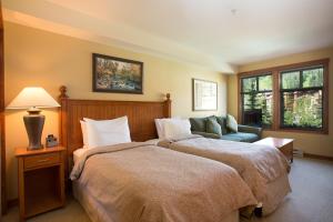 a hotel room with two beds and a couch at 2211 - Two Bedroom Standard Eagle Springs East condo in Solitude