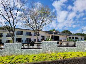 an exterior view of a building with a stone wall at Villa 33 Kashikojima in Ugata