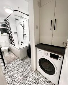 a bathroom with a washer and dryer in a room at belmont street in Hull