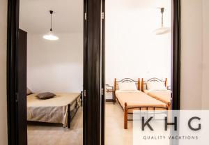 two beds in a room with a mirror at Irene apartment in Vlachata village! in Kefallonia
