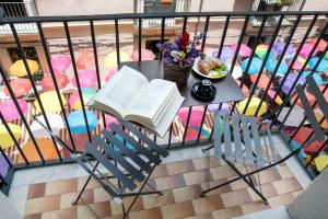 a table with a book and a plate of food on it at B&B Riccioli in Catania