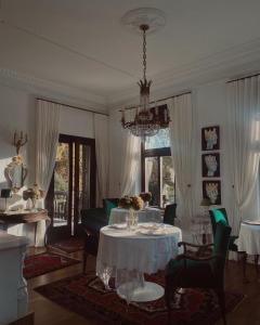 a living room with a table and a chandelier at Villa Pomona in Bled