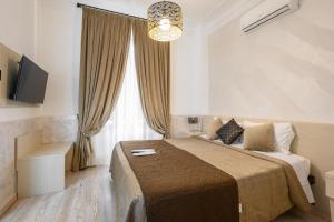 Postel nebo postele na pokoji v ubytování Cola Di Rienzo Suite Guest House