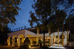 a house with a palm tree in front of it at Dao Villa in Dongshan