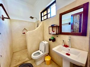 a bathroom with a toilet and a sink at Chikachika Beach B&B in Nungwi