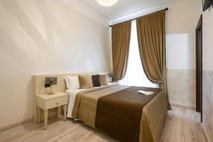 Postel nebo postele na pokoji v ubytování Cola Di Rienzo Suite Guest House