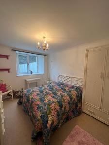 a bedroom with a bed with a colorful bedspread at The Nook at Sunnyside in Douglas