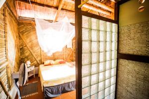 a bedroom with a bed and a net at Shuit Bambou in La Trinité