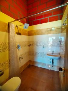 a bathroom with a sink and a shower and a toilet at Coffeeberry Hills Chikamagalur in Chikmagalūr