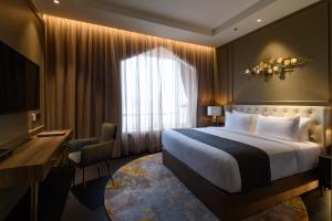 a hotel room with a large bed and a desk at The Granite Luxury Hotel Penang in George Town +139 photos