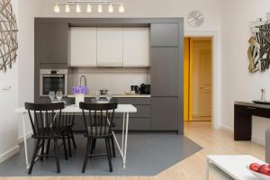 a kitchen with a table and chairs in a room at Western Side of Vistula River Apartment Radna by Renters in Warsaw