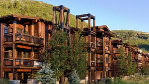 a group of wooden buildings with a mountain in the background at 1 Bedroom Condo with Spa - Silver Baron Lodge condo in Park City