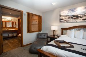 a hotel room with a bed and a chair at 1 Bedroom Condo with Spa - Silver Baron Lodge condo in Park City +21 photos