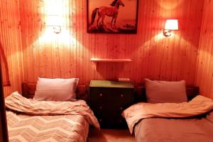 una habitación con 2 camas y una foto de un caballo en la pared en Sweet Home, en Neraidochori