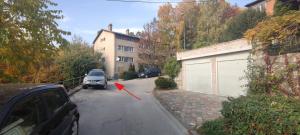 a car parked in a parking lot with a red arrow at Small (34m2) modern apartment with parking place in Sarajevo