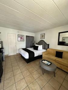 a hotel room with a bed and a couch at Holiday Isles Resort in St. Pete Beach