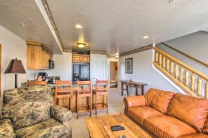 a living room with a couch and a table at Cozy Eden Condo Retreat Less Than 6 Mi to Ski Resort! in Eden