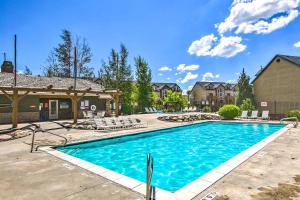 a swimming pool in a yard with chairs and a house at Cozy Eden Condo Retreat Less Than 6 Mi to Ski Resort! in Eden
