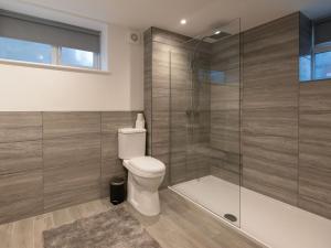 a bathroom with a toilet and a glass shower at The Suffolk-uk41441 in Brandon