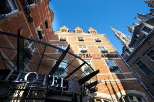 a building with a sign on the front of it at Rocco Forte Hotel Amigo in Brussels