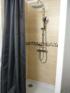 a shower with a shower curtain in a bathroom at Gîte d’Eros in Saint-Valery-sur-Somme +19 photos